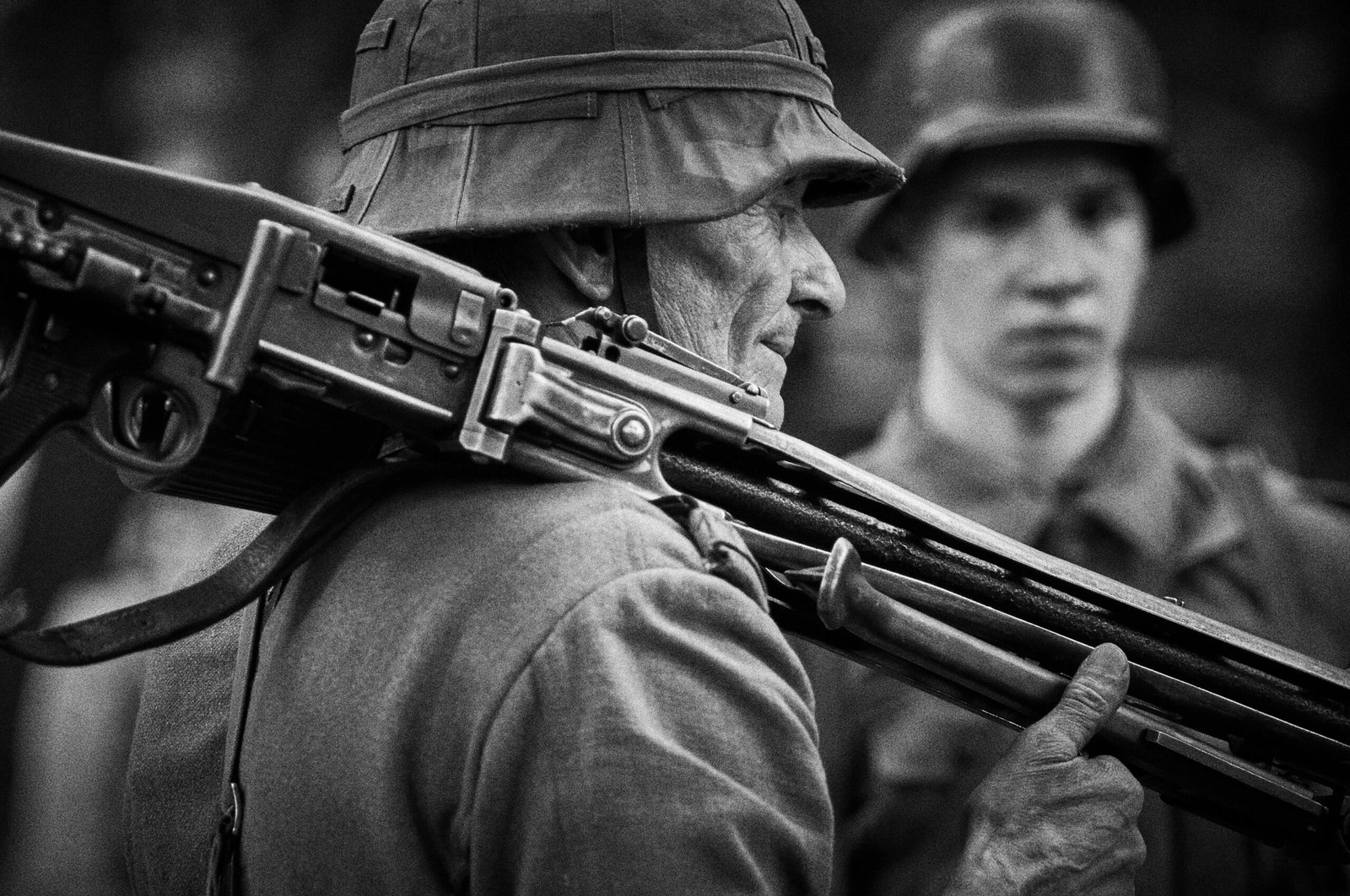 Black and white photo of soldiers with rifles in historical attire.