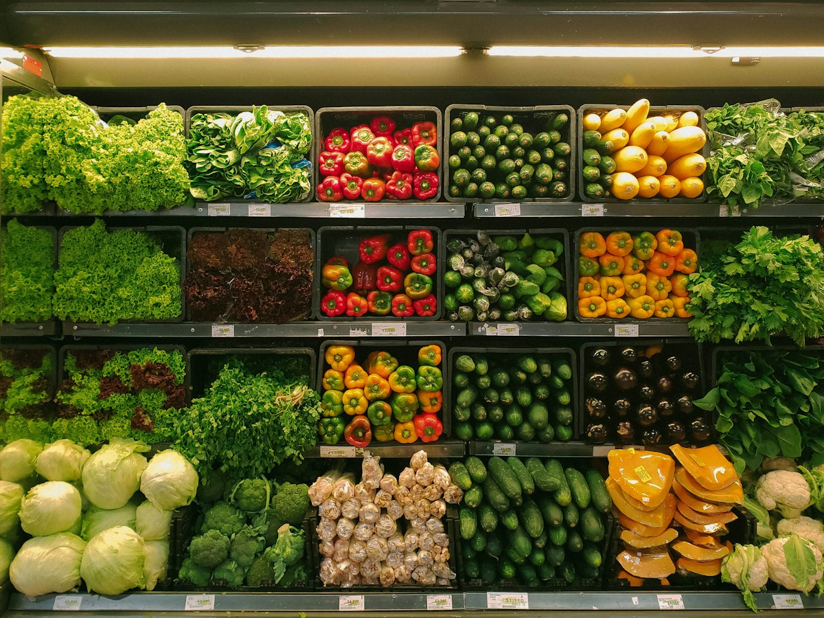 Rows of fresh produce and supermarket aisles illustrating a large-scale grocery store video challenge